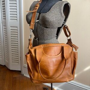 Includes cross-body, back-pack straps,dust-bag also included.